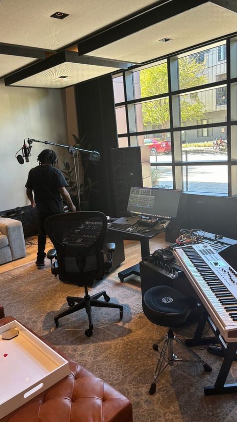 Modern recording studio workspace with keyboard